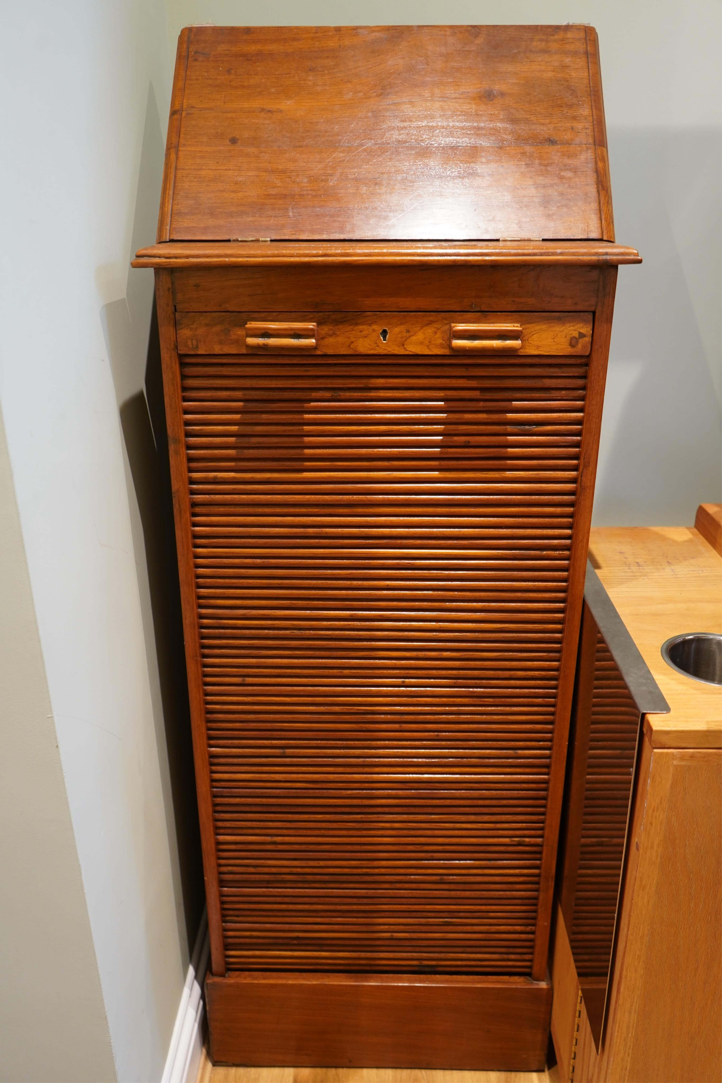 A 20th century Anglo Indian teak tambour filing cabinet, with lift up top and drawers, width 53cm, depth 42cm, height 121cm. Condition - good